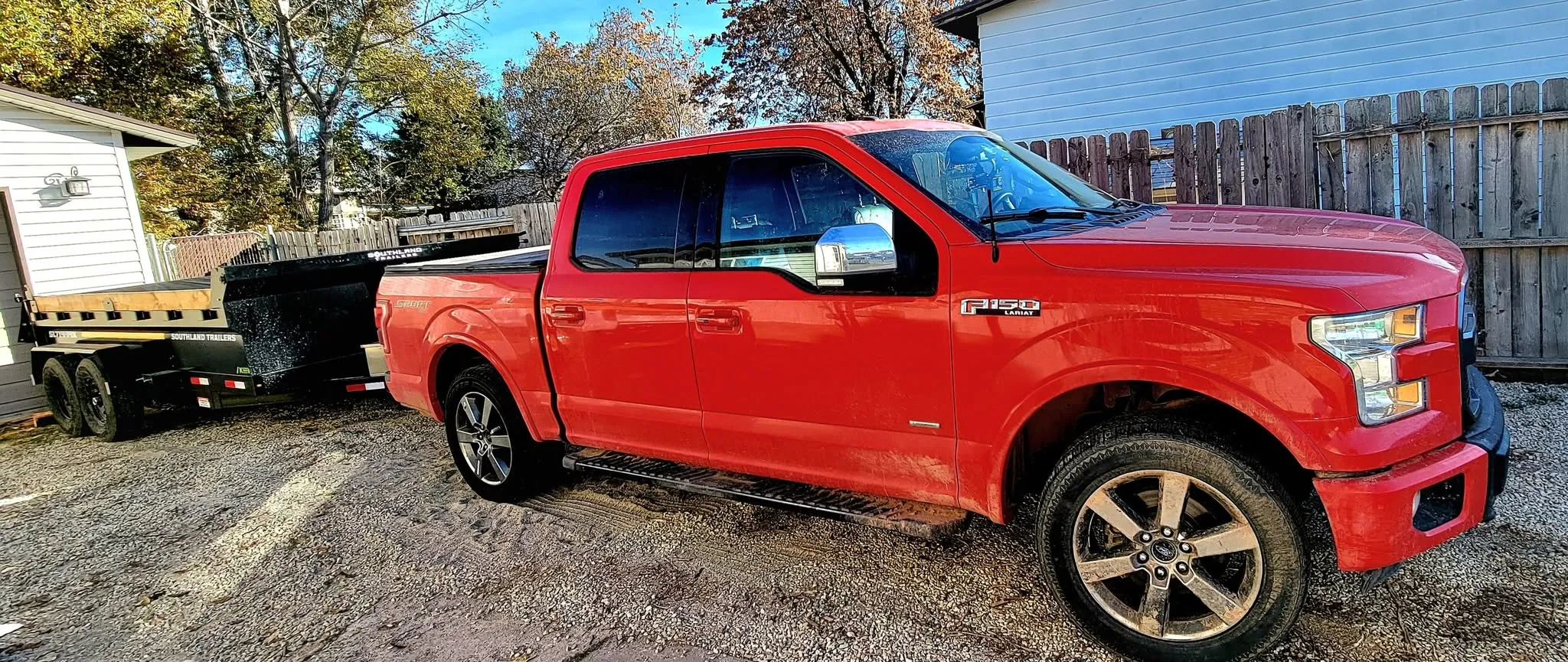AmCron LLC red Ford F-150 with attached black dump trailer