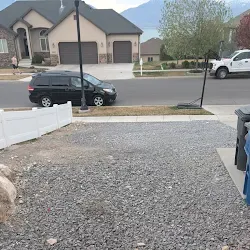 Cleared driveway after the junk haul, with mountain view in the distance